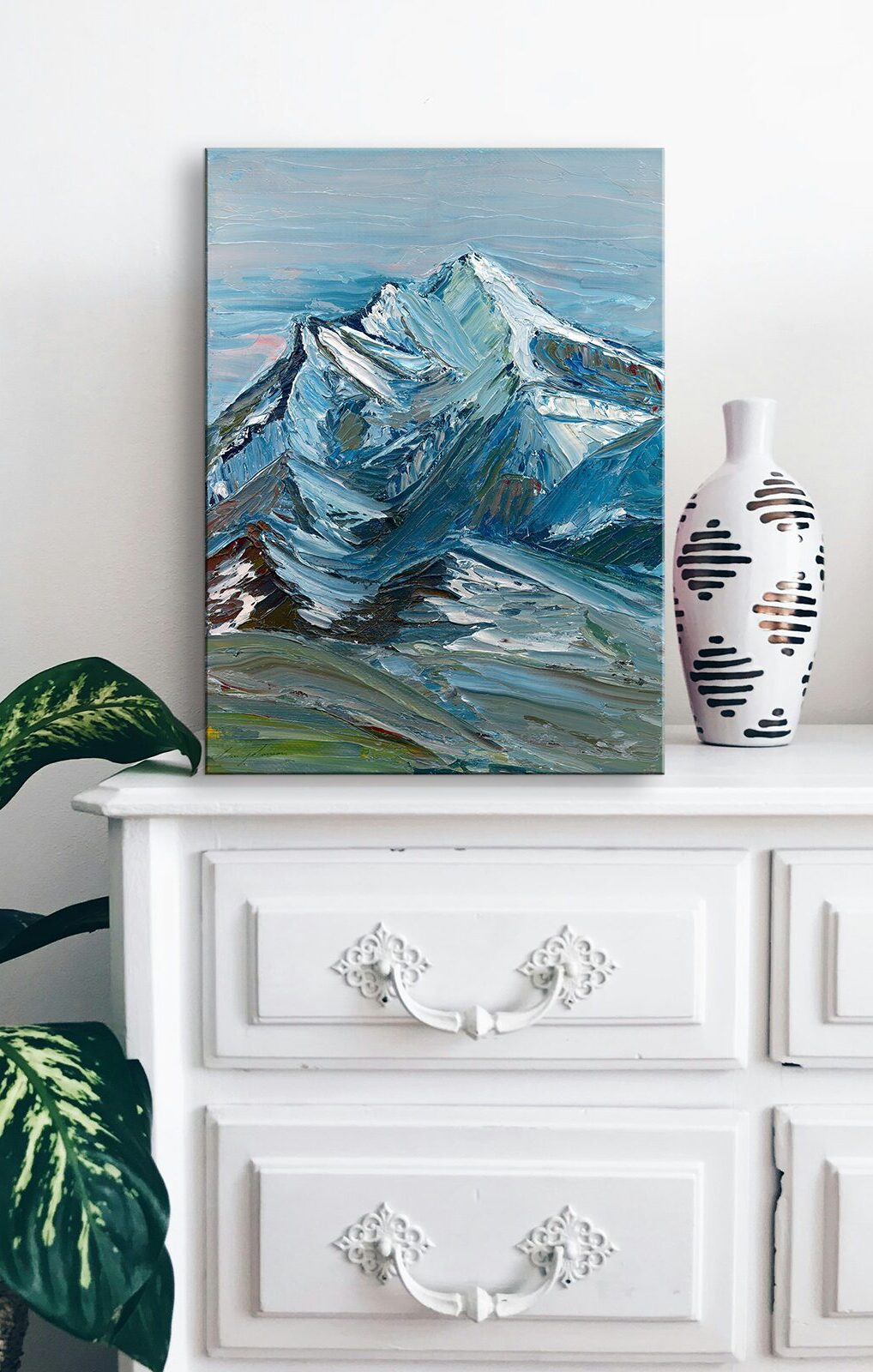 Painting of a mountain peak on a dresser