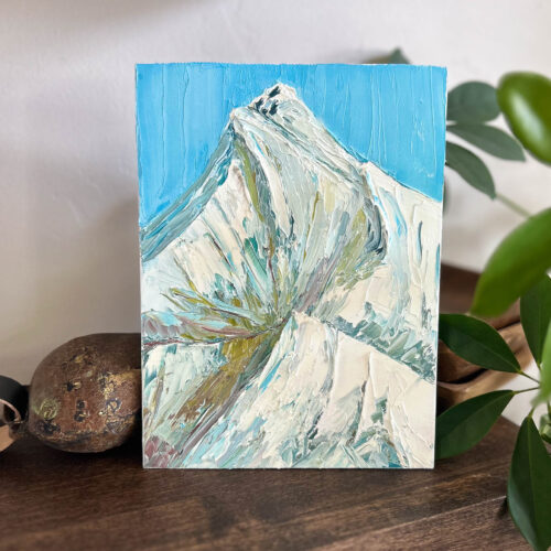 Product image of a mountain peak with a blue sky.