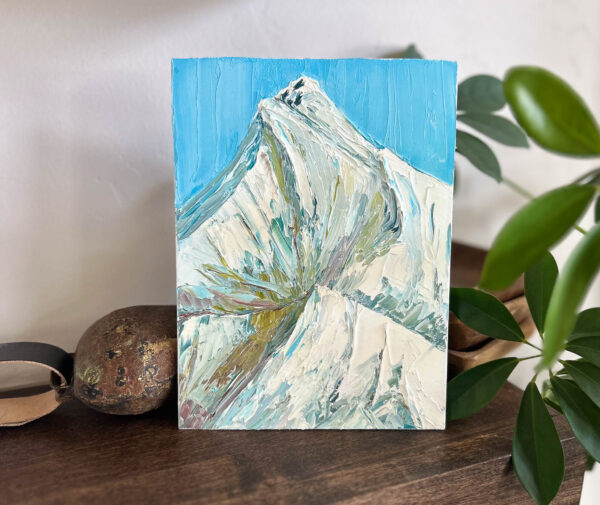 Product image of a mountain peak with a blue sky.